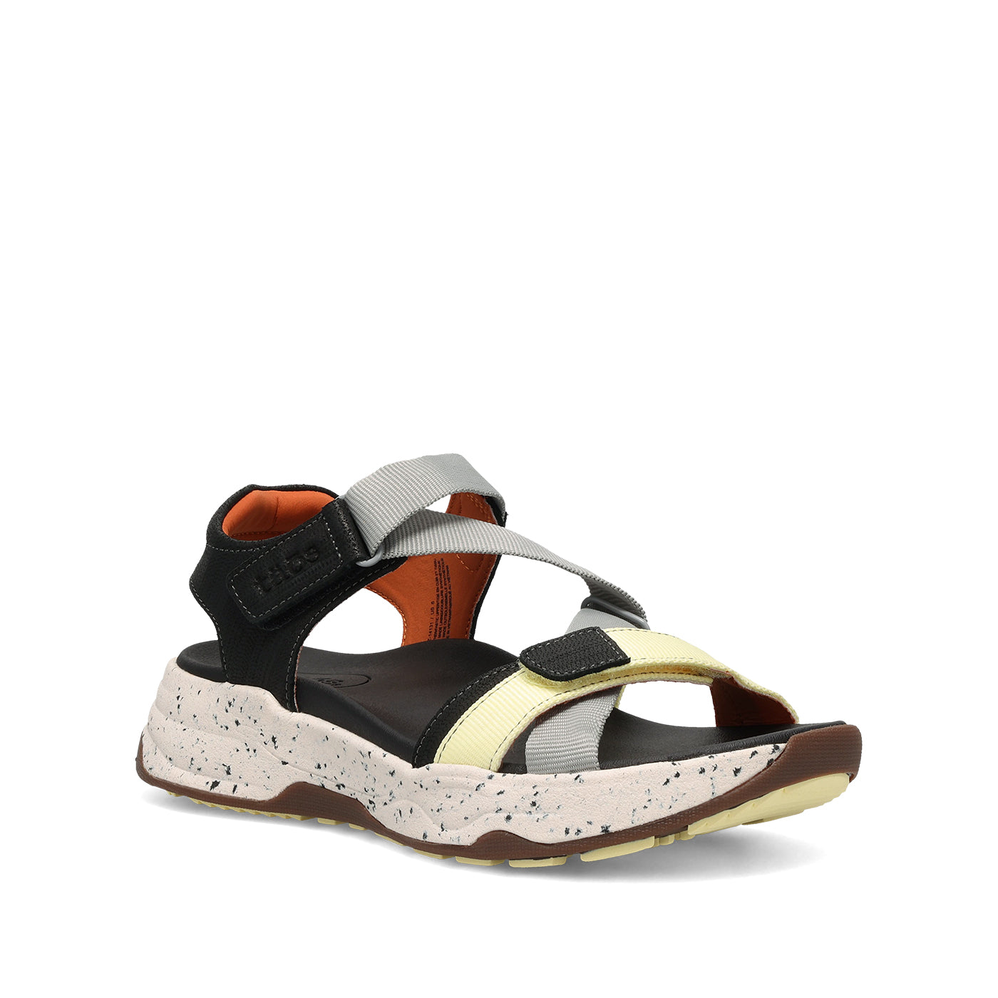 Multicolored sandal with black, white, and brown accents on a white background