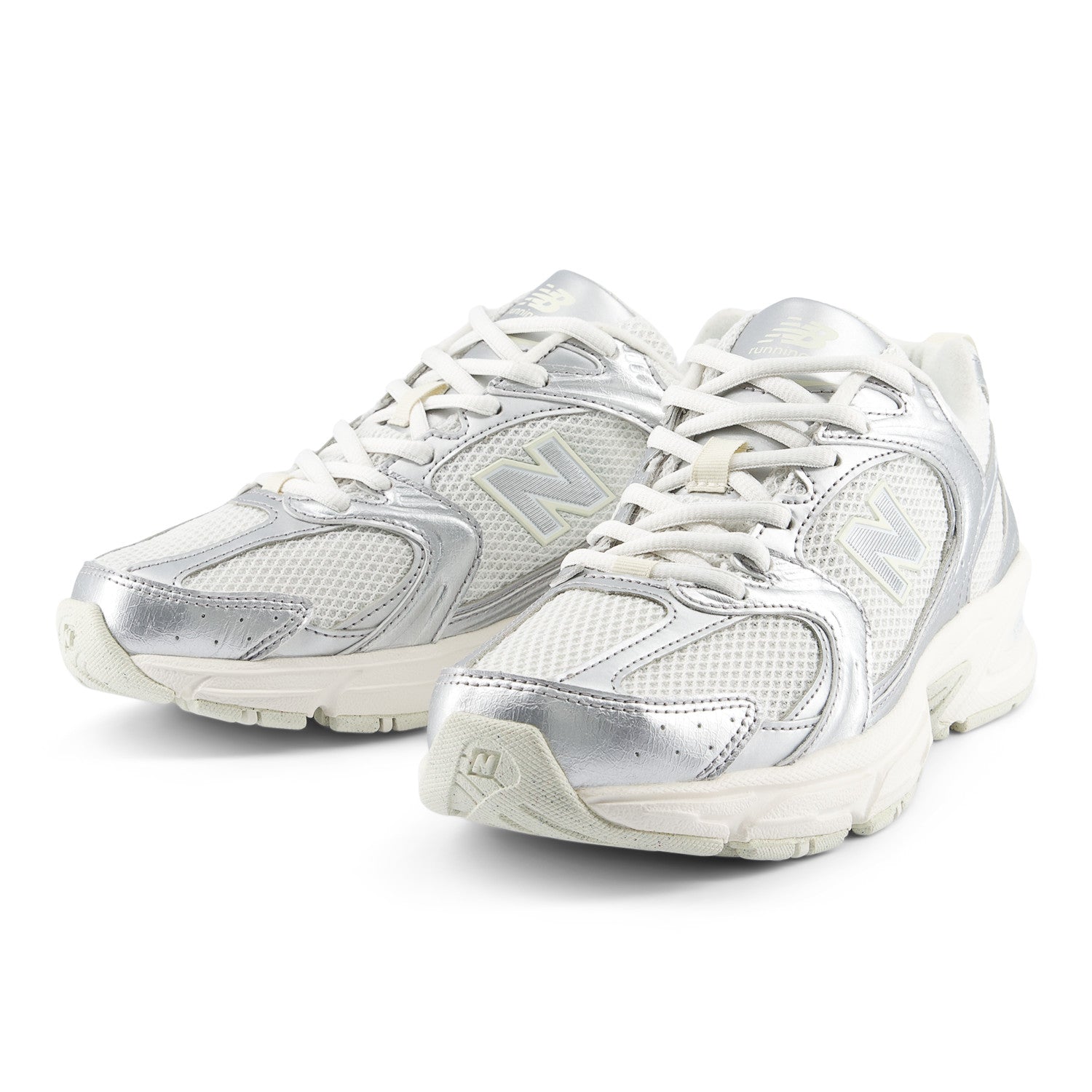 Pair of silver athletic shoes on a white background