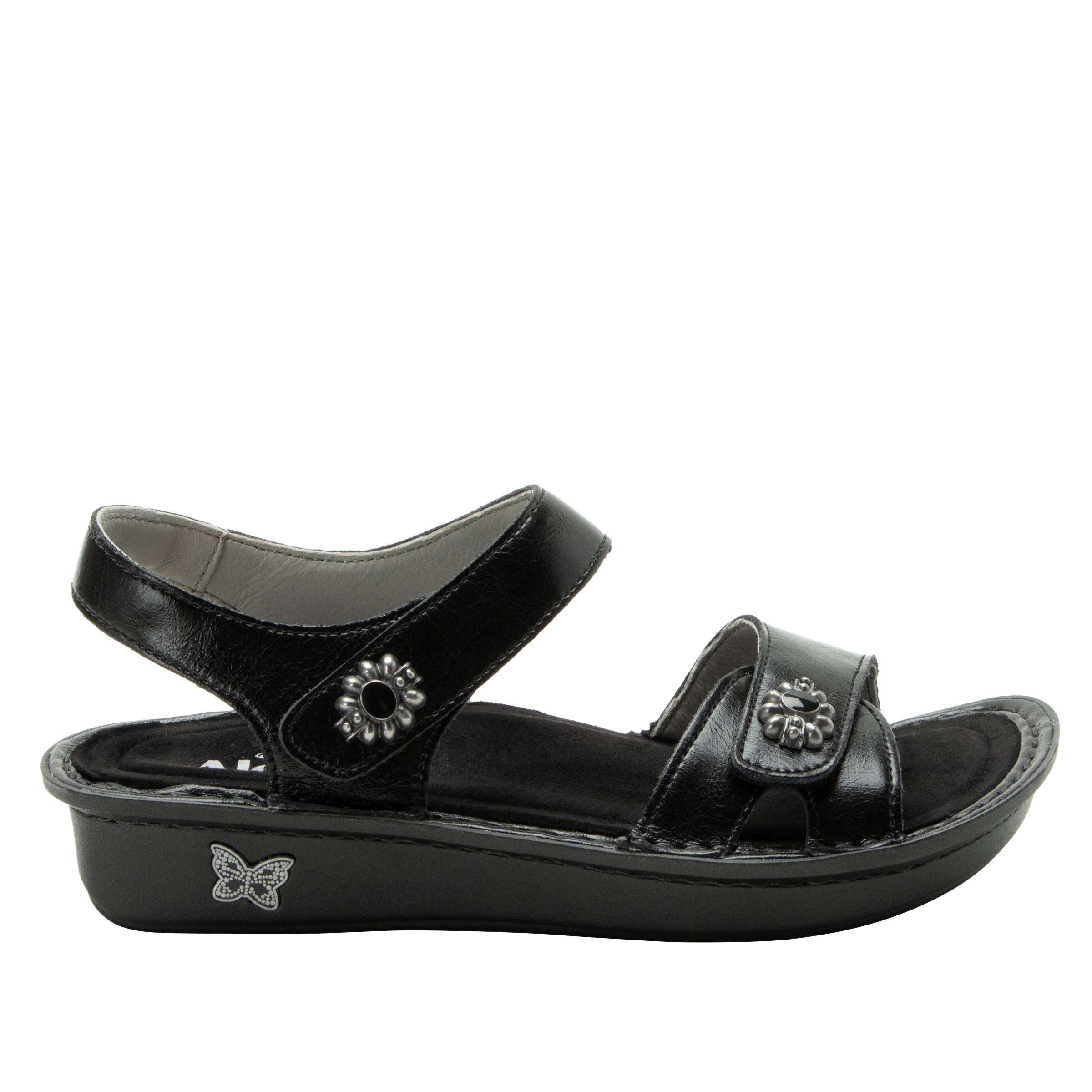 Black sandal with decorative straps on a white background