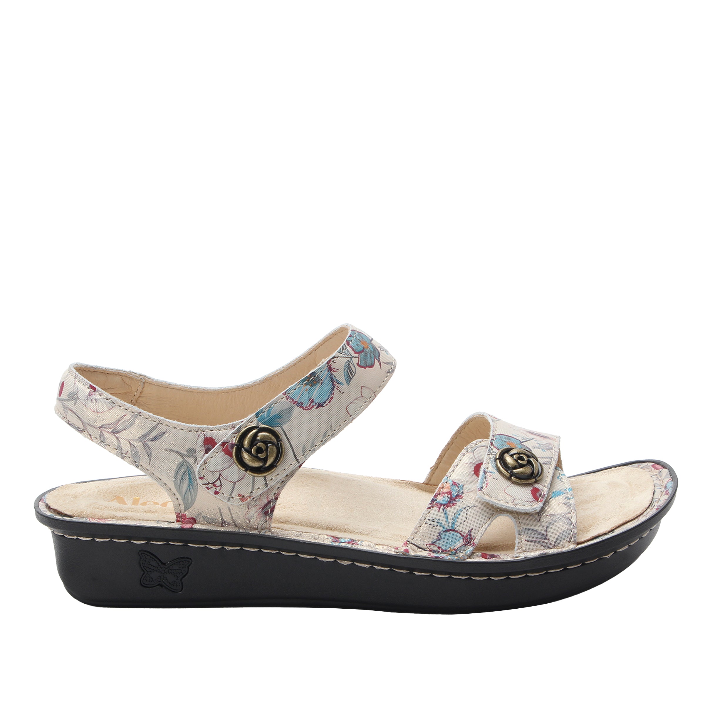 Floral-patterned sandal with a black sole on a white background