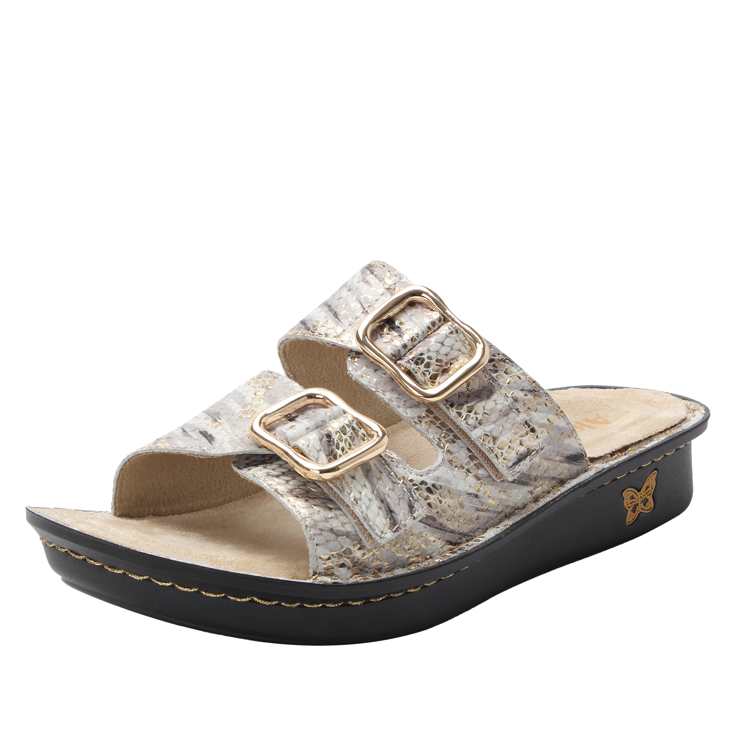 Wedge sandal with cork texture and gold buckles on a white background
