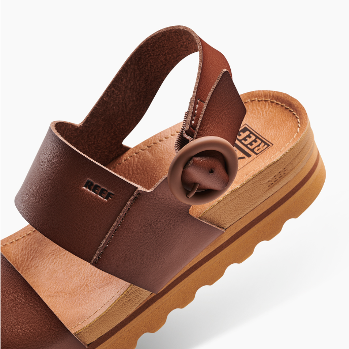 Brown sandal with strap on a white background