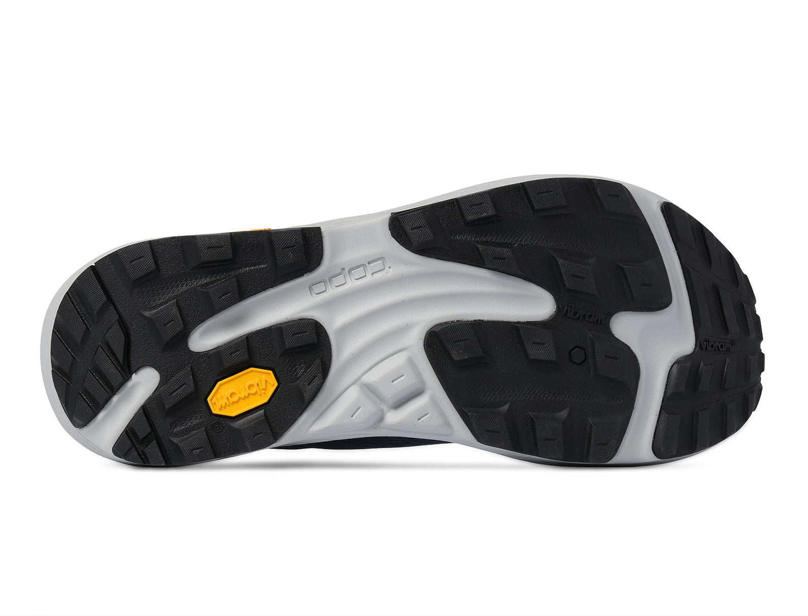 Close-up of a black and white shoe sole with a yellow label on a white background