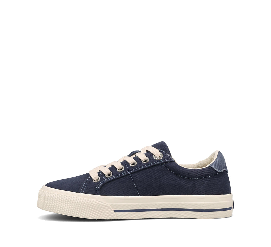 Navy blue sneaker with white laces on a white background
