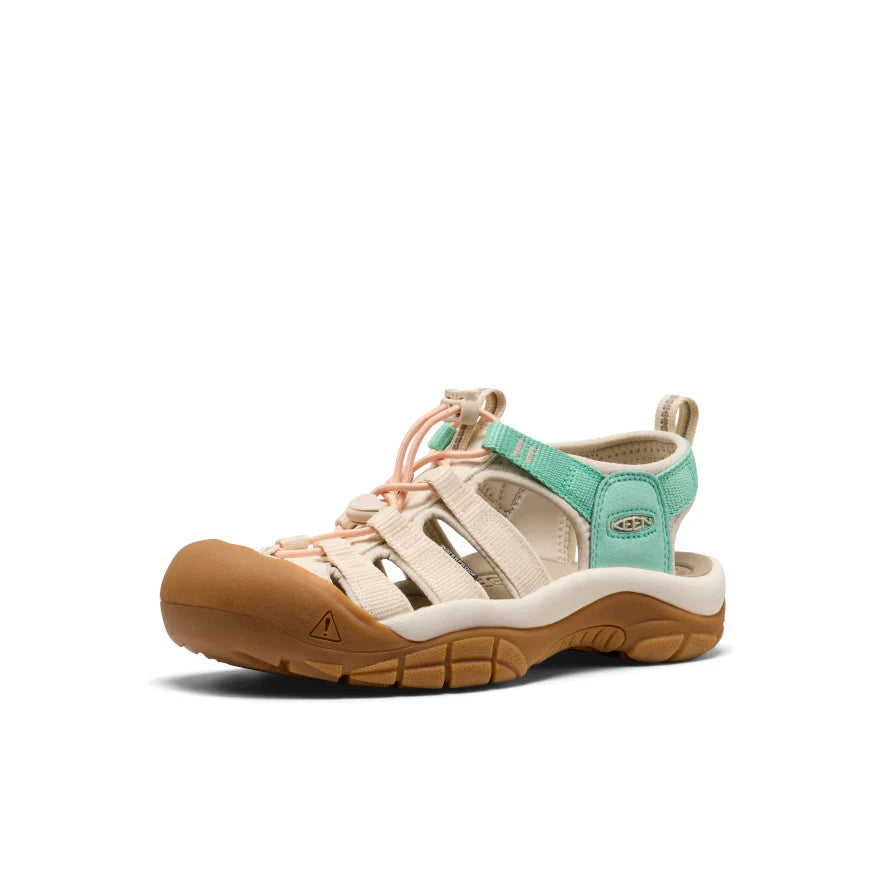 Sandal with brown sole and beige and teal straps on a white background
