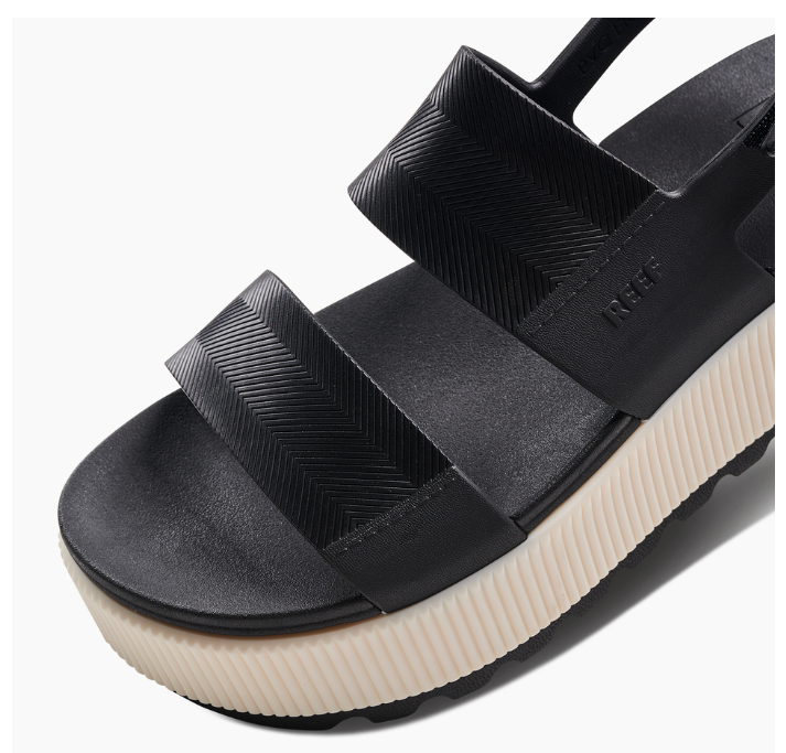 Black platform sandal with white sole on a white background