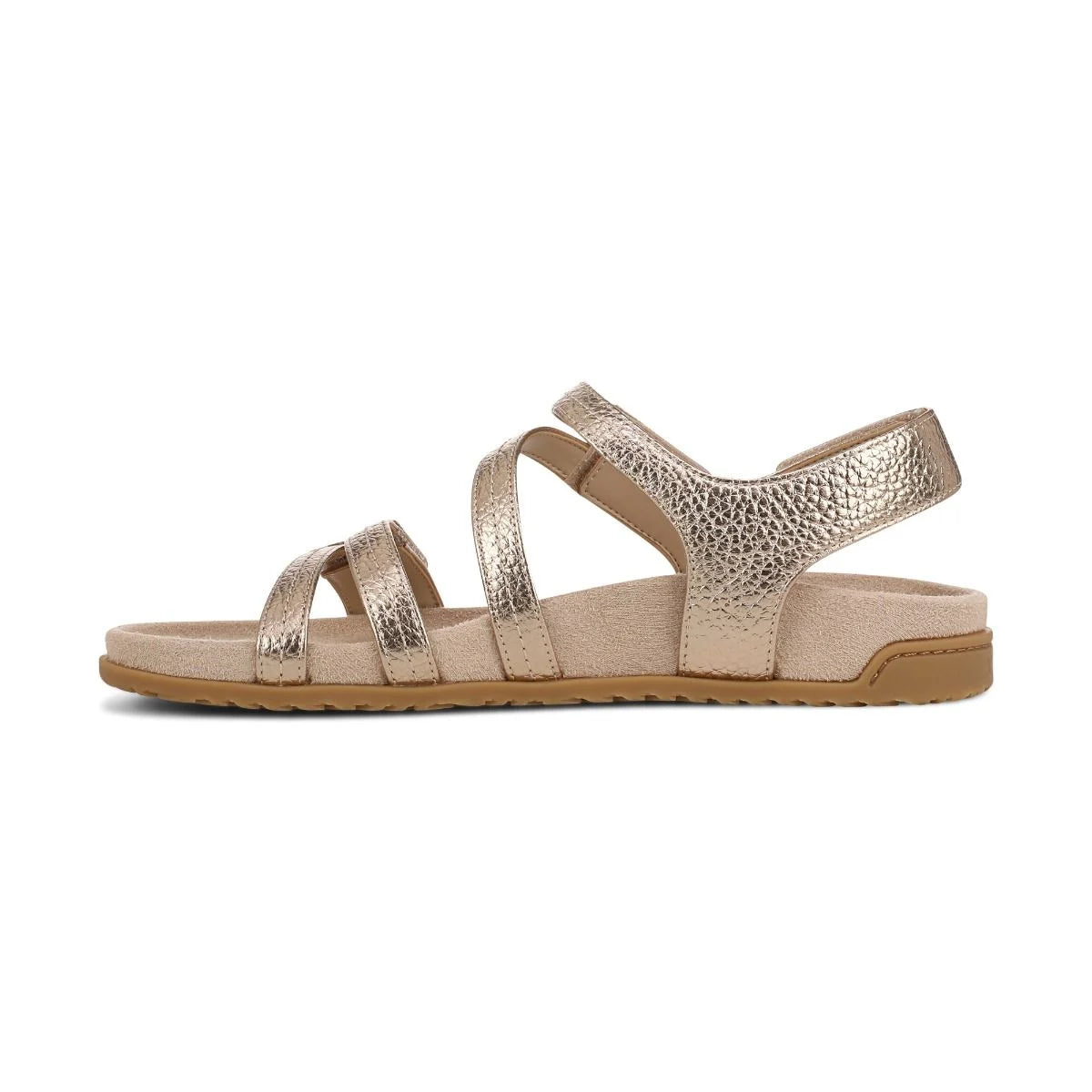 Gold sandal with criss-cross straps on a white background