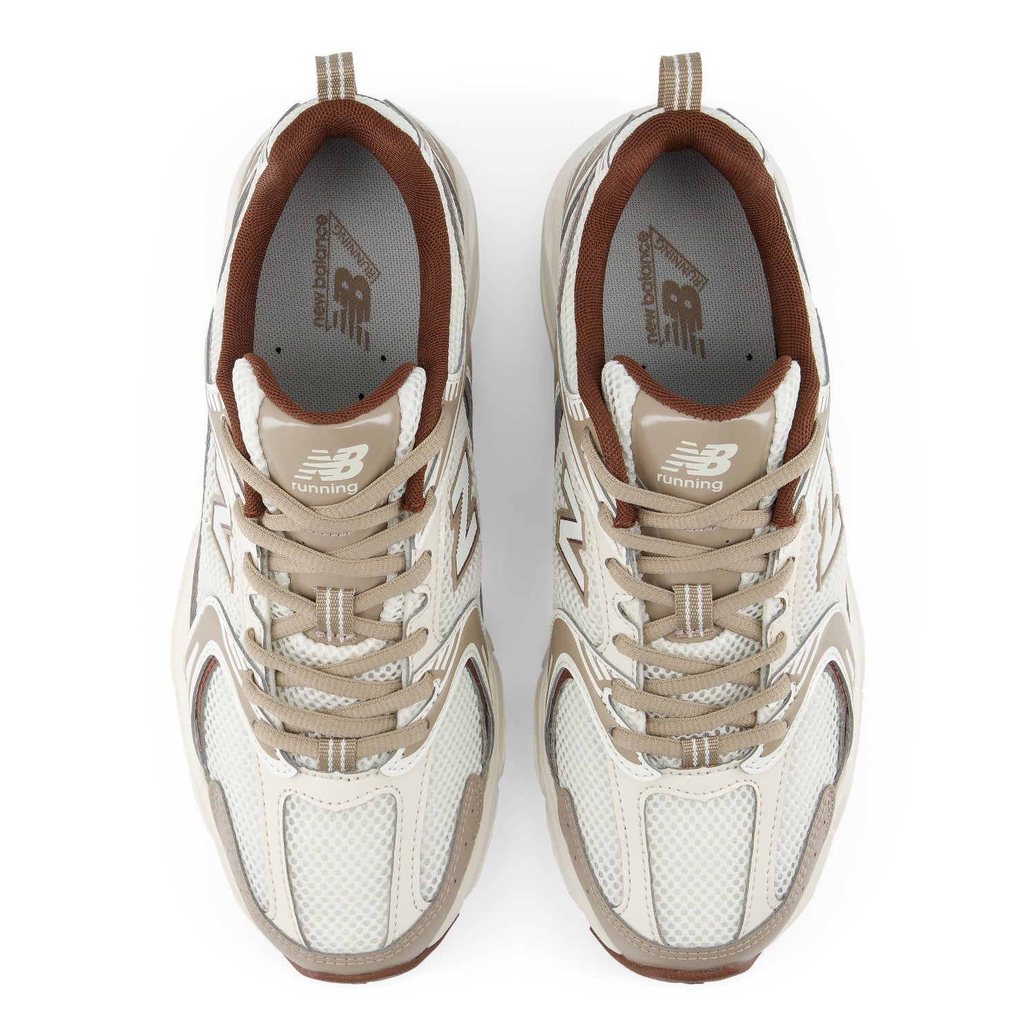 A pair of New Balance 530 sneakers shown from a top-down view on a white background. The shoes feature a cream and beige mesh upper with brown accents, including the lining, tongue, and outsole.