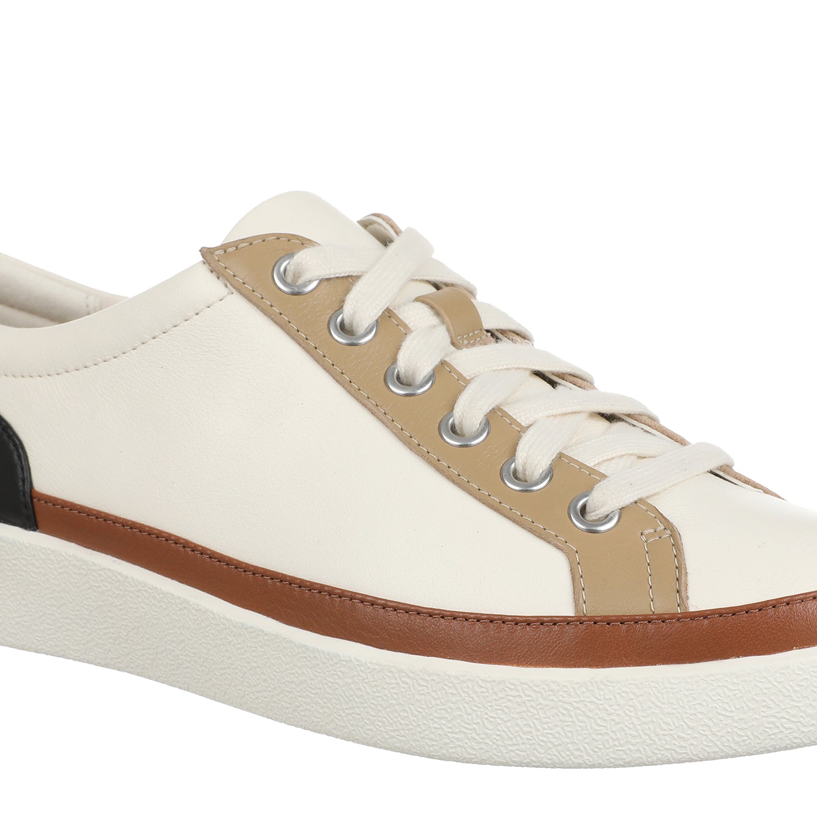 A low-top sneaker with an off-white leather upper, beige side panels, a brown leather stripe, a black heel accent, and a thick off-white sole.