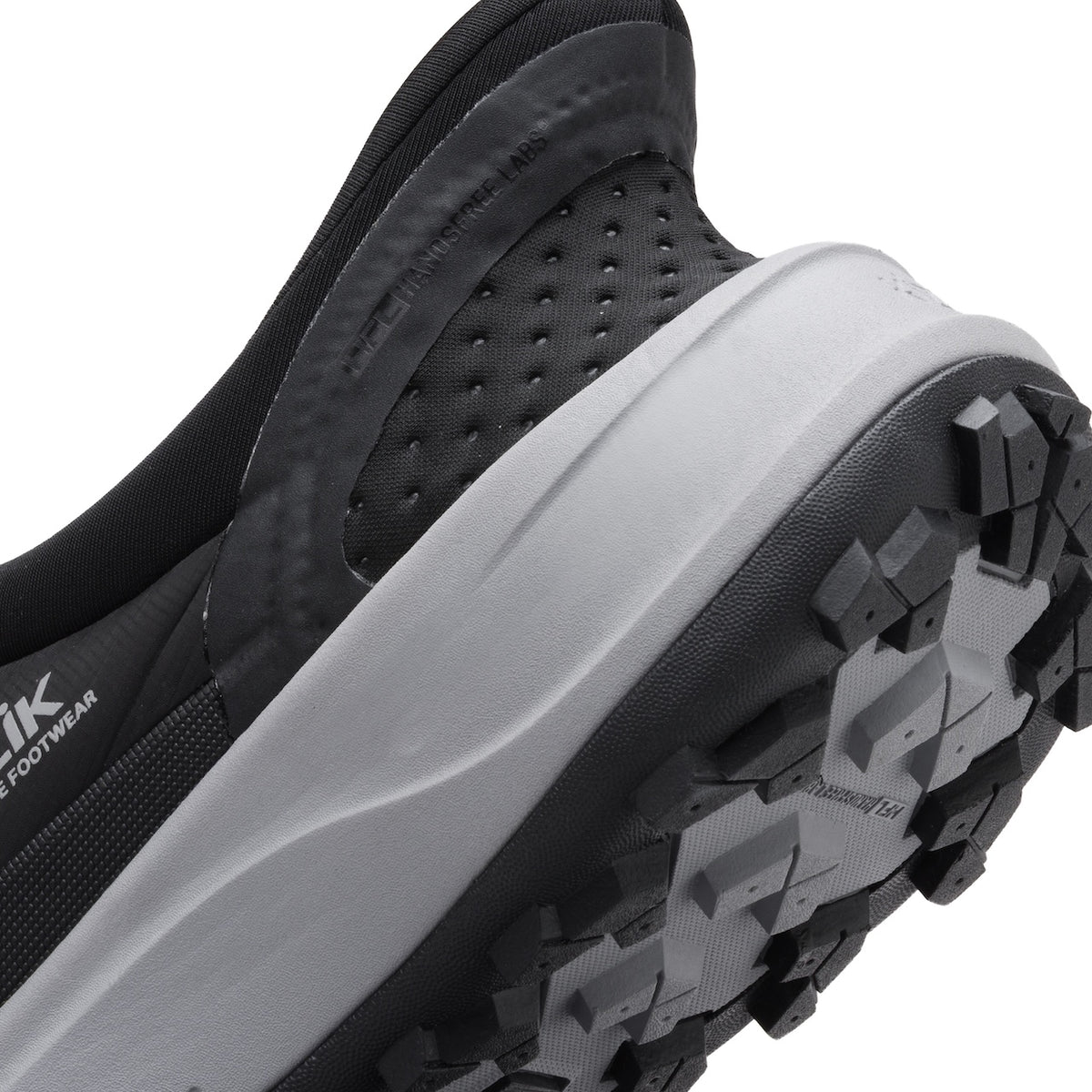 Close-up of a black and gray hiking shoe with a brand logo on a white background