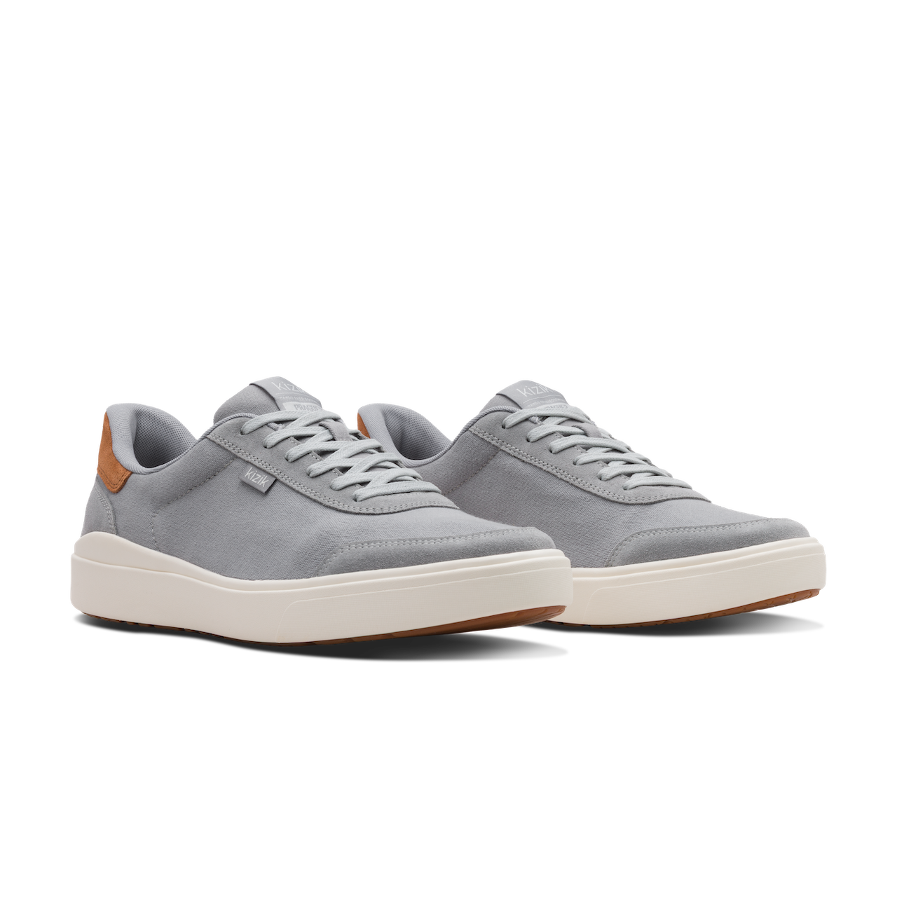 Pair of white sneakers with a subtle pattern on a white background