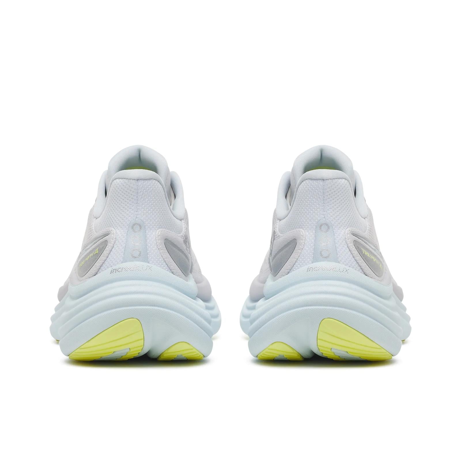 White sneakers with yellow accents on a white background