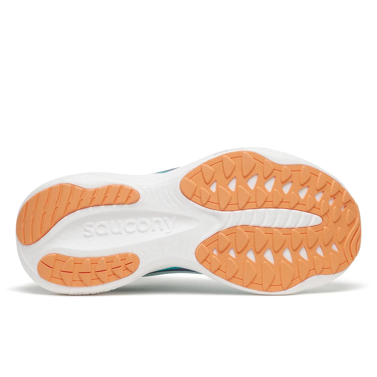 Sole of a shoe with orange tread pattern on a white background