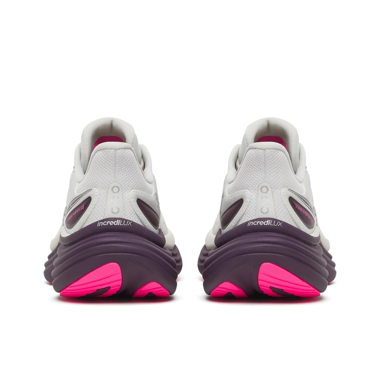 White athletic shoes with pink soles on a white background
