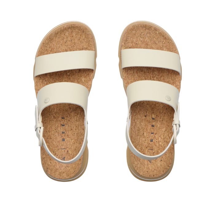 Pair of cork sandals with white straps on a white background