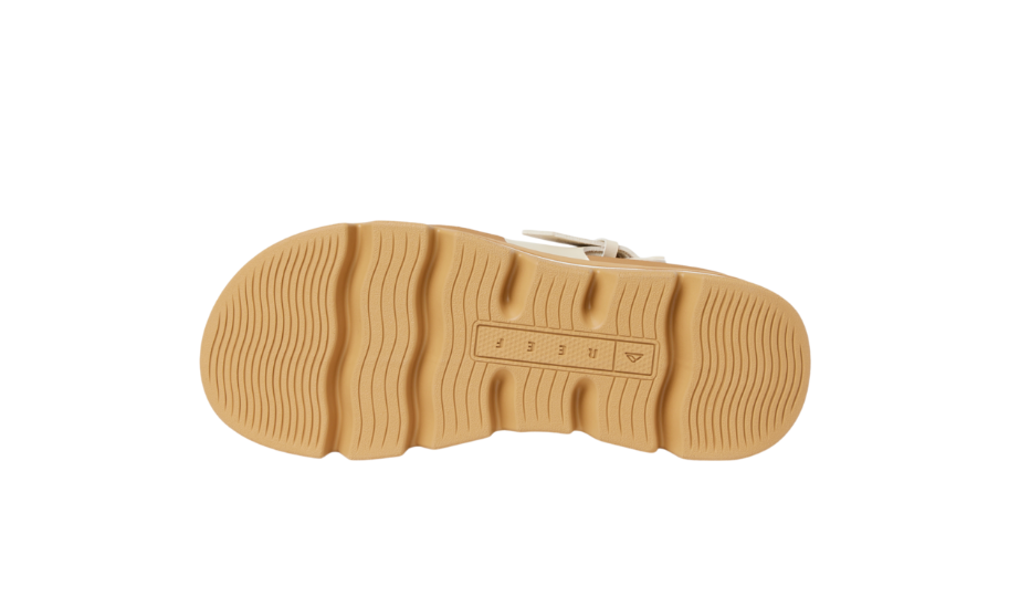 Tan sole of a shoe on a white background