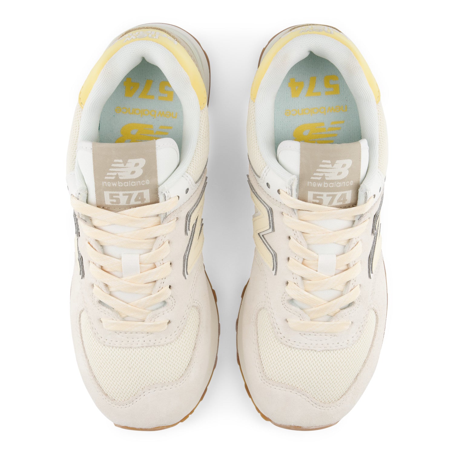 Pair of white sneakers with yellow accents on a white background