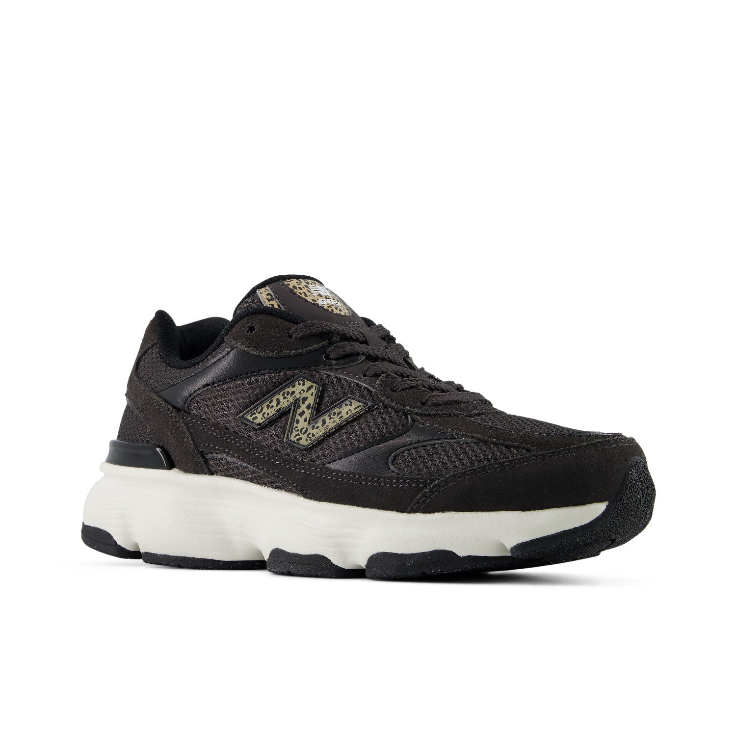 A black New Balance sneaker with a chunky white midsole and a textured gold 'N' logo on the side, shown against a plain white background.