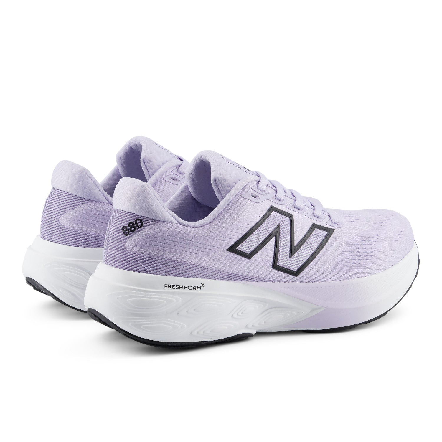 Pair of purple running shoes with New Balance logo on a white background