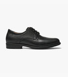 Black slip-on sneaker with white sole on a light gray background