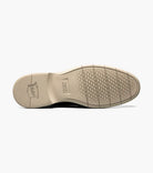 Close-up of a shoe sole with brand logo on a white background