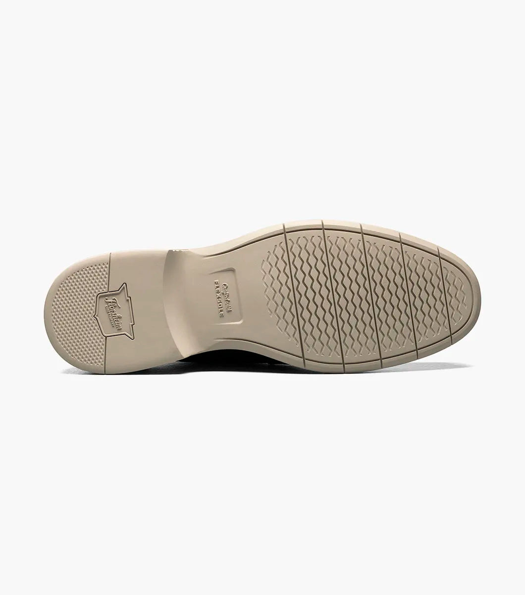 Close-up of a shoe sole with tread pattern on a white background