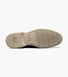 Close-up of a shoe sole with tread pattern on a white background