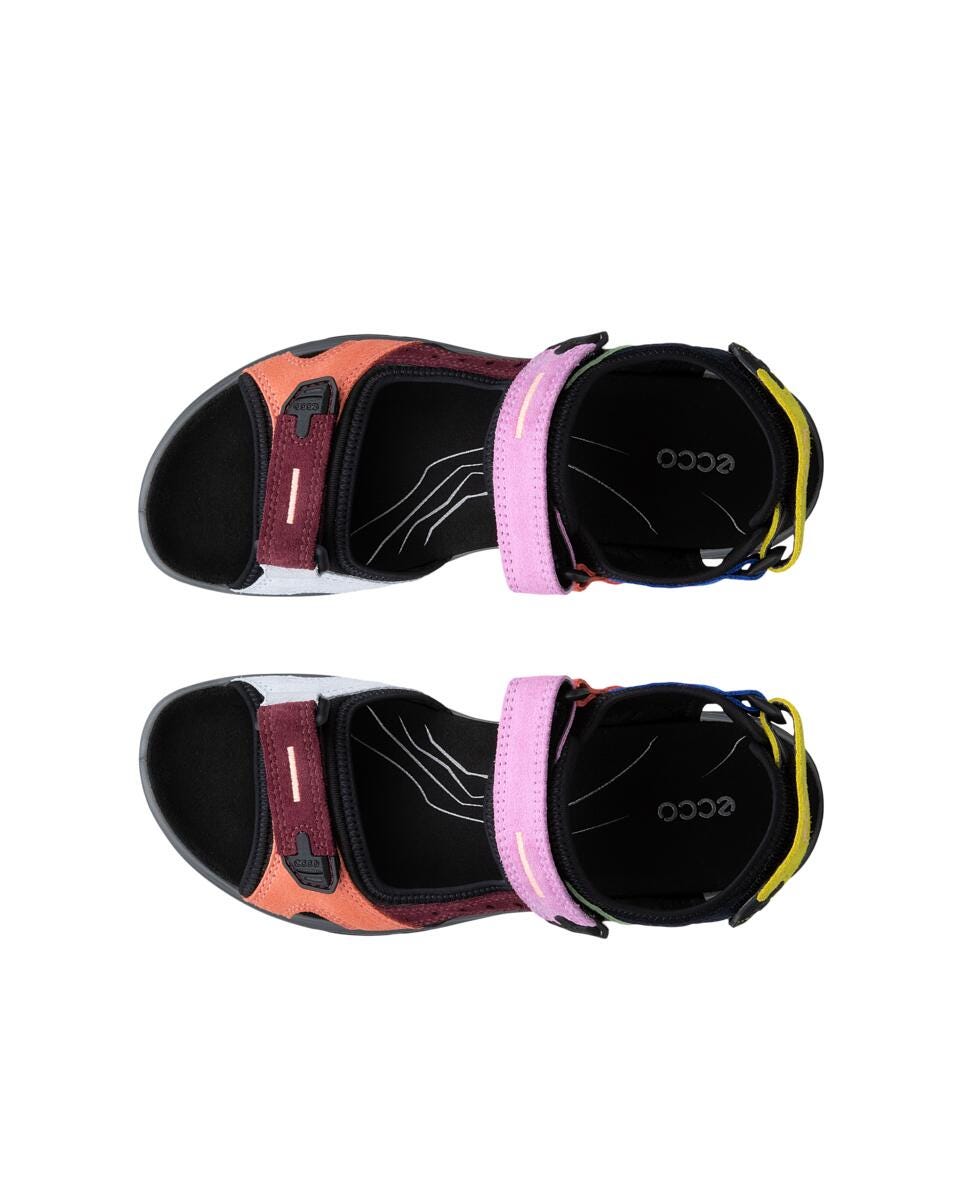 Pair of colorful sandals with a pink strap on a white background
