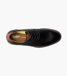 Black leather dress shoe with Florsheim branding on a white background