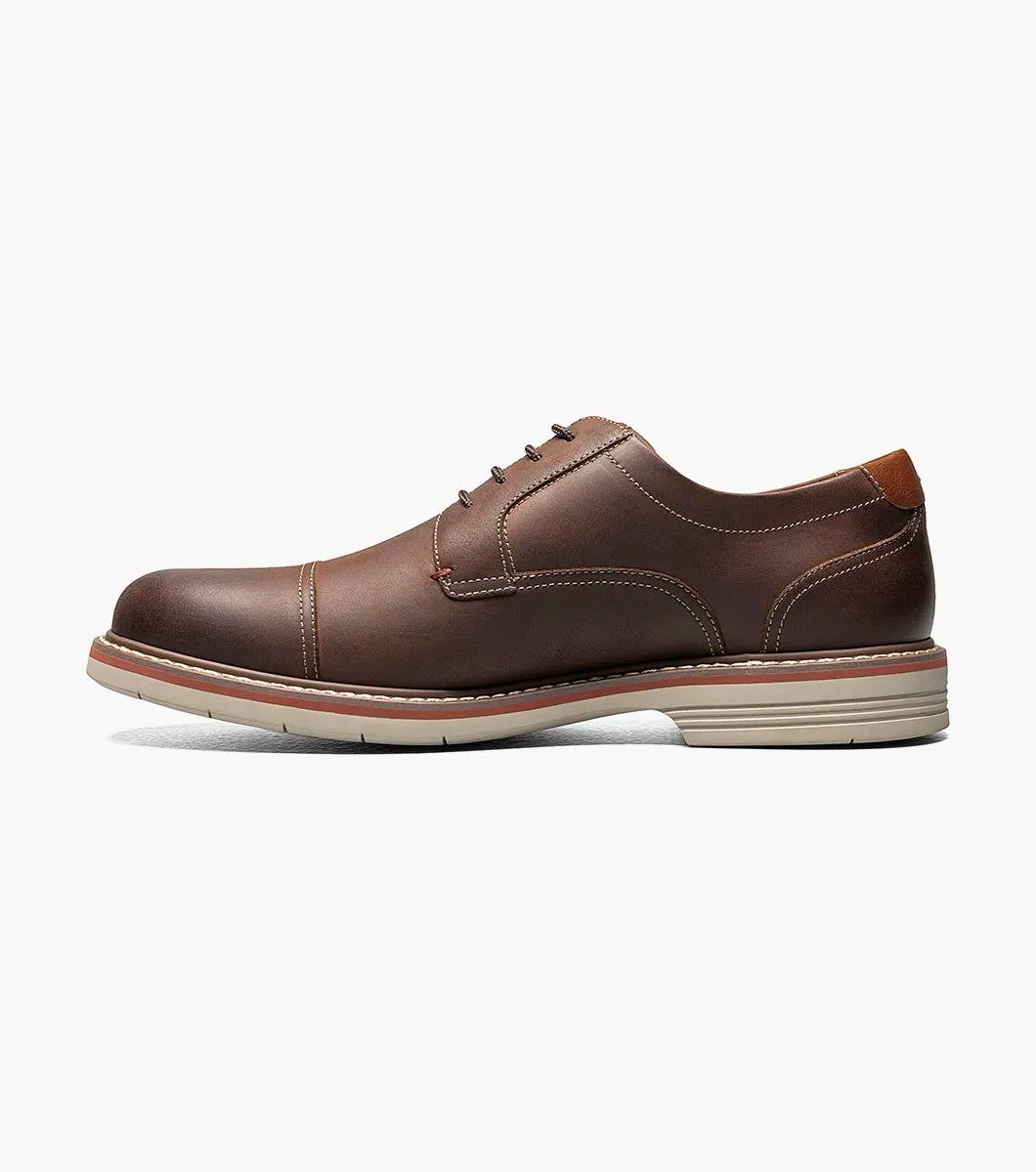 Black leather shoe with decorative elements on a white background