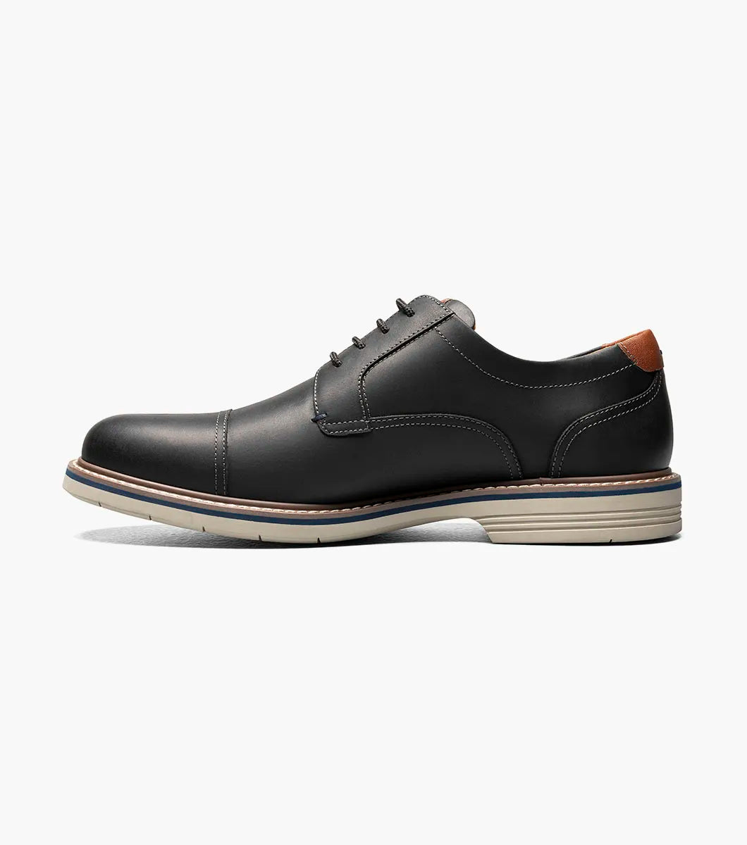 Black leather shoe with decorative elements on a white background