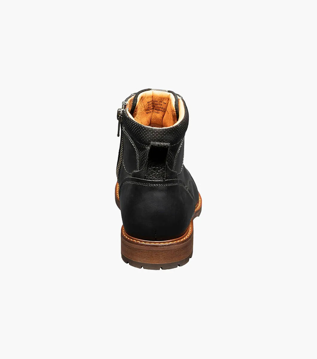A black leather ankle boot shown from the back, featuring a brown sole and a tan interior lining, set against a plain white background.