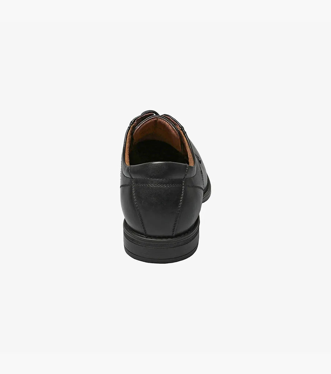 Black leather dress shoe on a white background