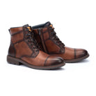 Pair of brown leather boots on a white background