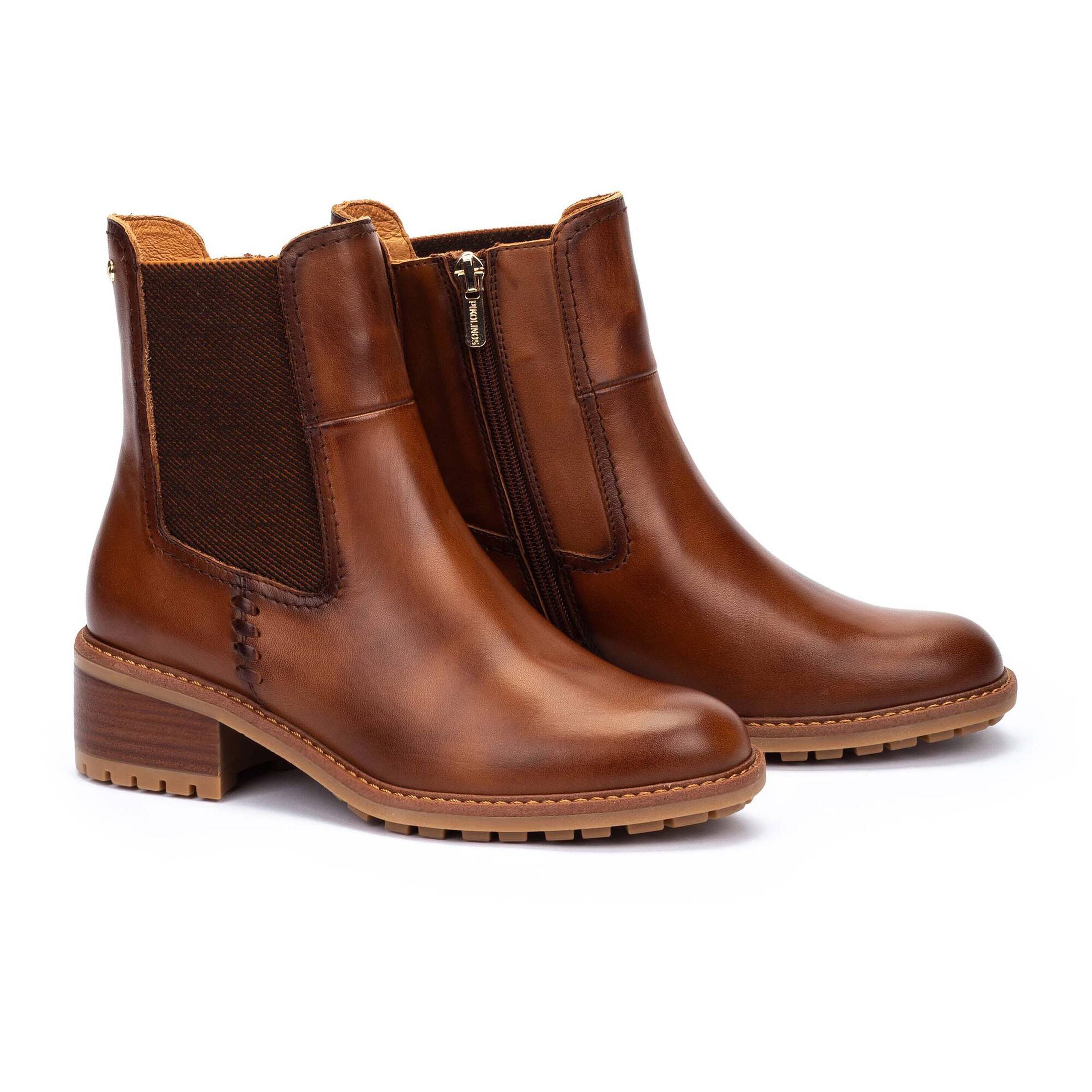 A pair of women's brown leather Chelsea-style ankle boots with dark brown elastic side panels and a low block heel, shown on a plain white background.