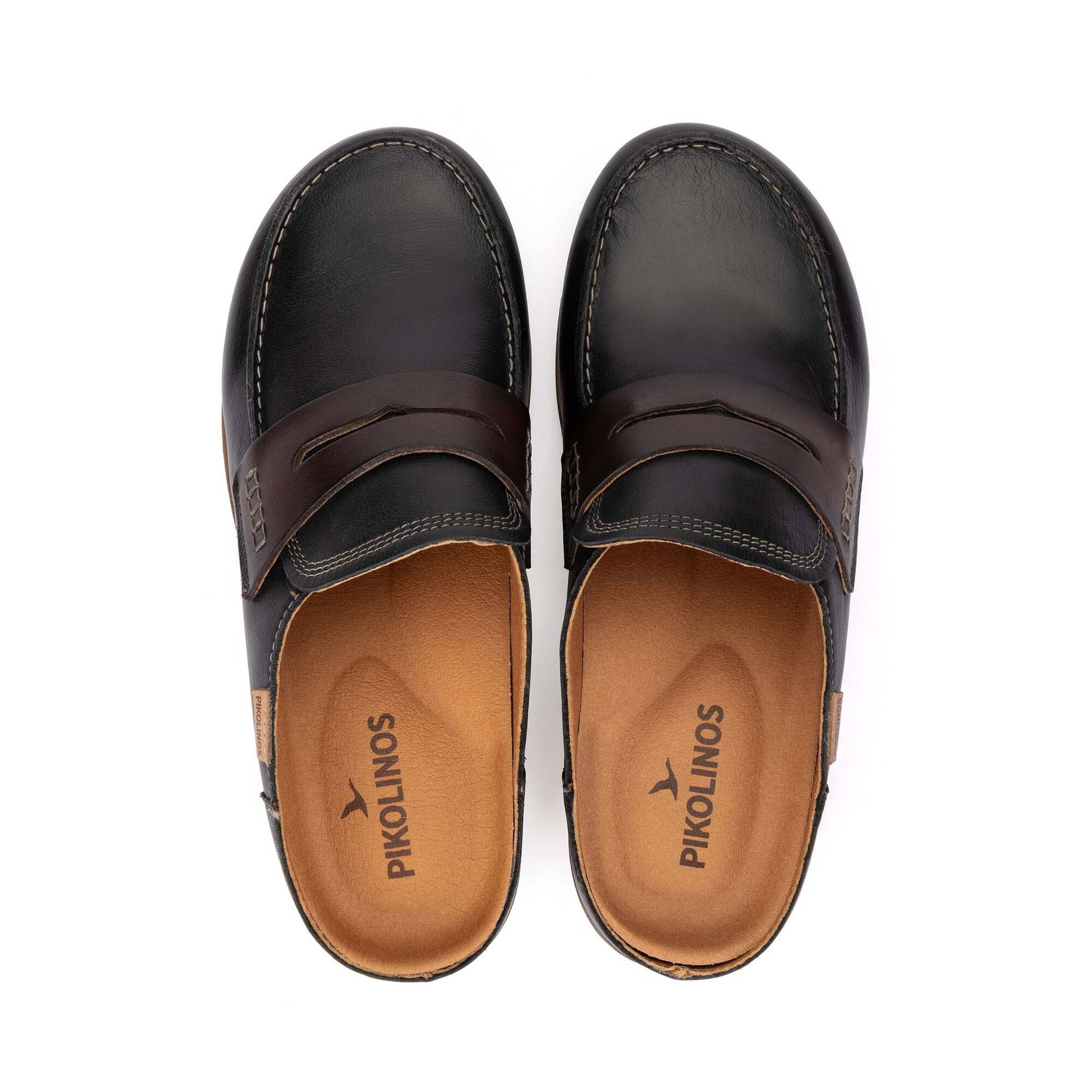 A pair of men's dark brown leather penny loafers shown from a top-down view on a white background, with the brand name 'PIKOLINOS' printed on the tan insoles.