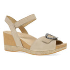Beige wedge sandal with cork wedge sole on a white background