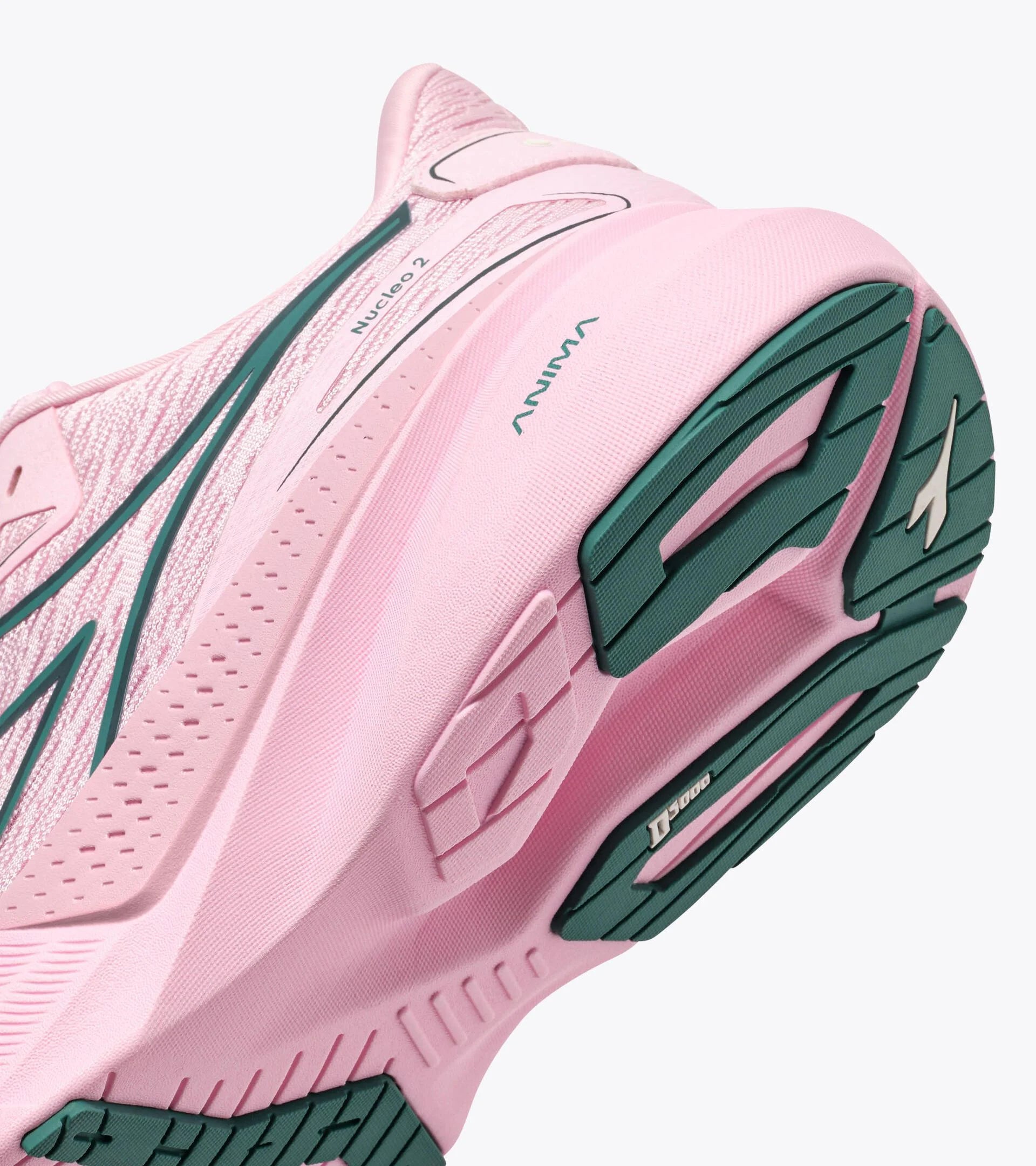 Pink running shoe with green sole on a white background