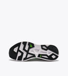 Black and white athletic shoe with green accents on a white background