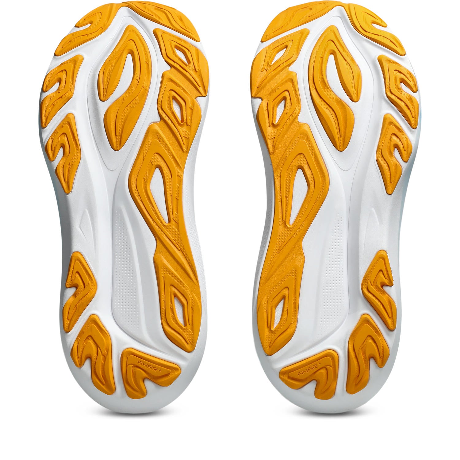 Close-up of white and orange athletic shoe soles on a white background