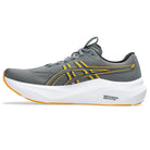 Gray running shoe with yellow accents on a white background