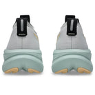 Light gray and green sneakers with black accents on a white background