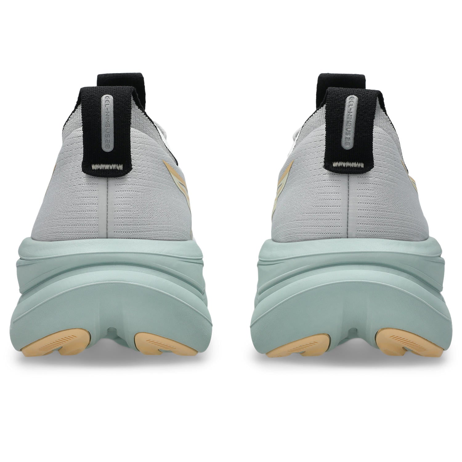 Light gray and green sneakers with black accents on a white background
