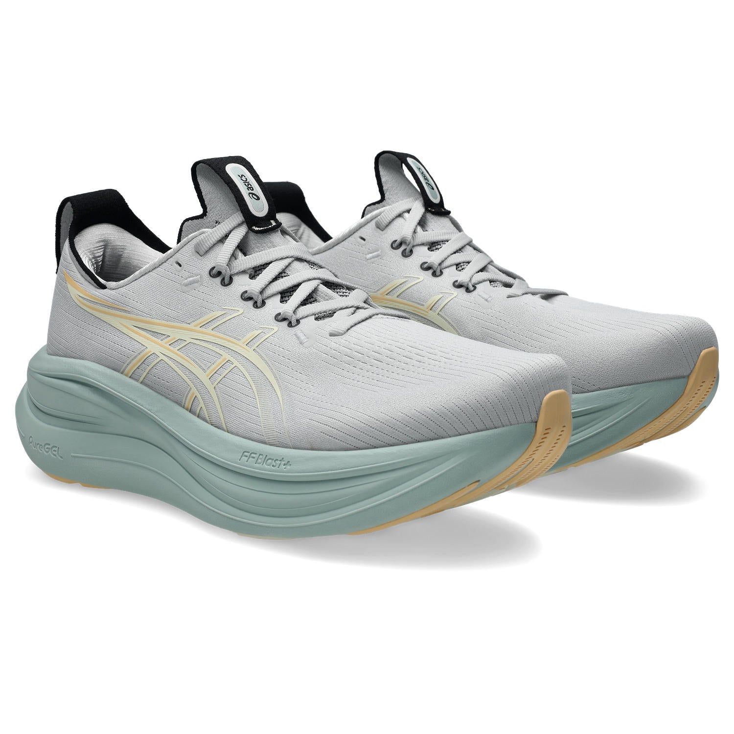 Gray running shoes with green soles on a white background
