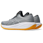 Gray running shoe with white sole and orange accent on a white background