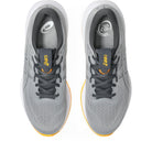 Gray running shoes with yellow accents on a white background