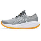 Gray running shoe with orange sole on a white background