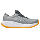 Gray running shoe with white sole and orange heel on a white background