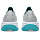 Pair of gray and teal running shoes on a white background