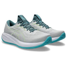 Gray and teal running shoes on a white background